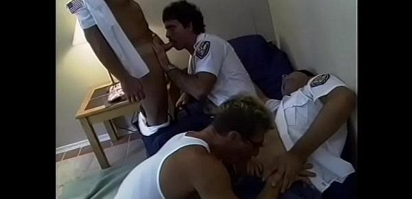  Hairy fireman sits back on a bed while getting his hard cock sucked